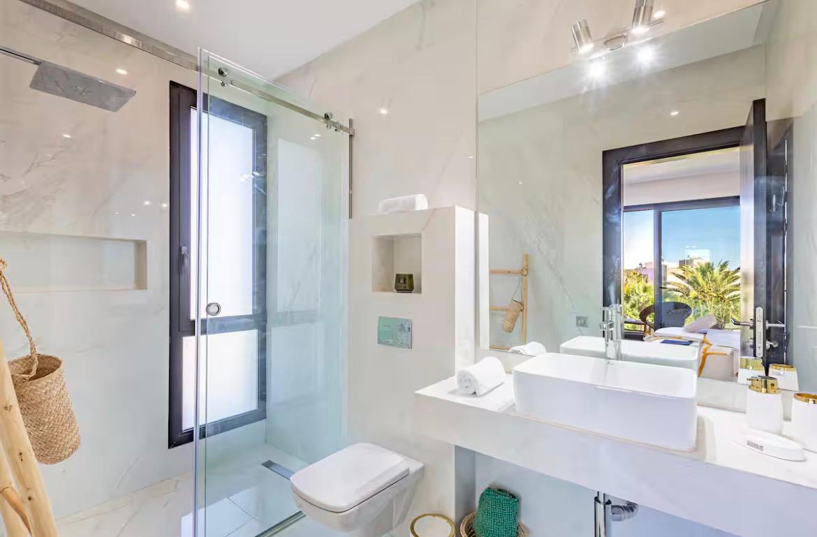 Marble en-suite bathroom with walk-in shower at The Palm