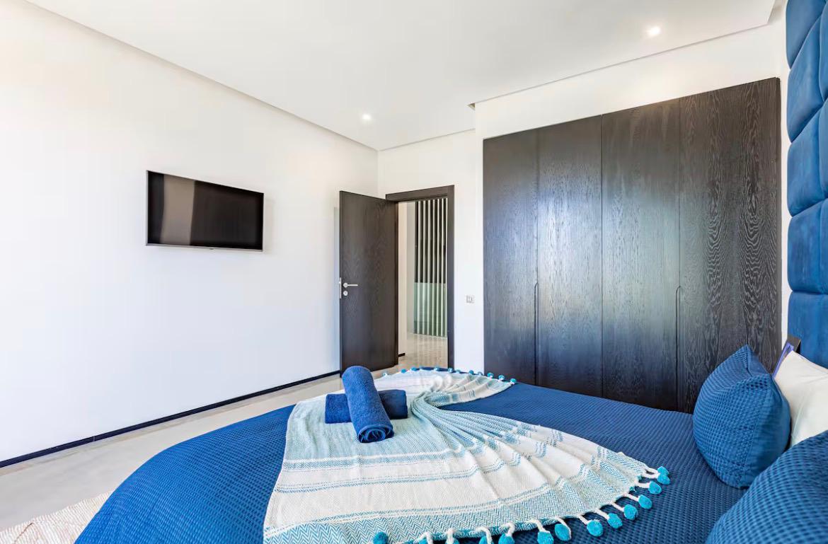 Guest bedroom with fitted wardrobes and smart TV at The Atlas