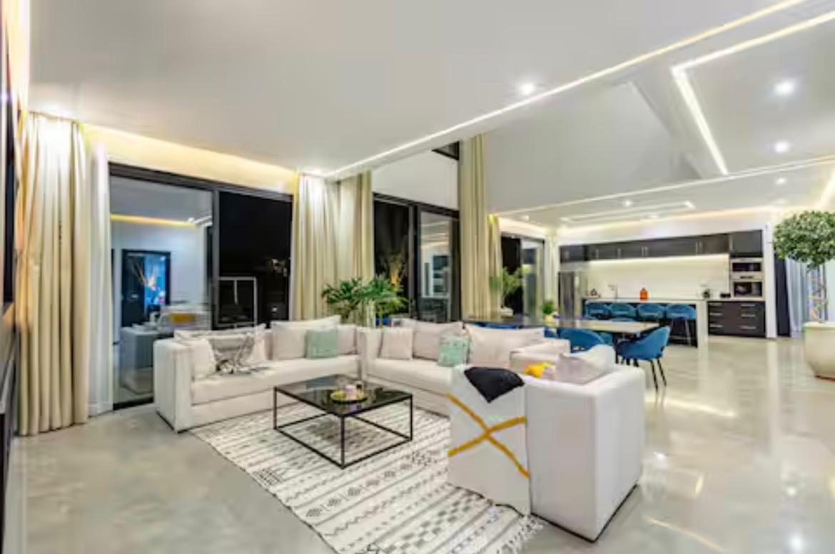 Open-plan living room and kitchen lit at night at The Palm