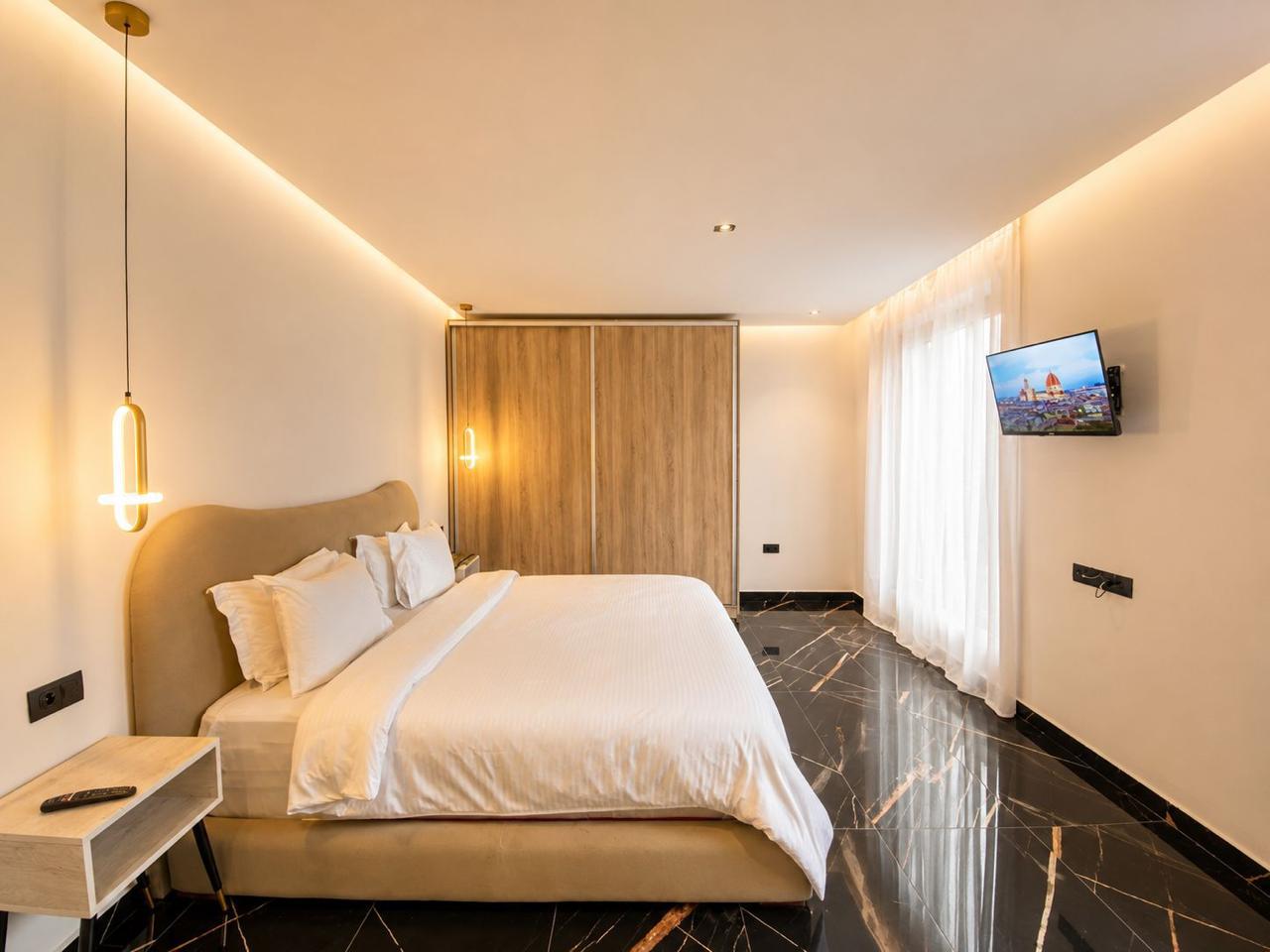 Guest bedroom with marble floors and smart TV at The Majorelle